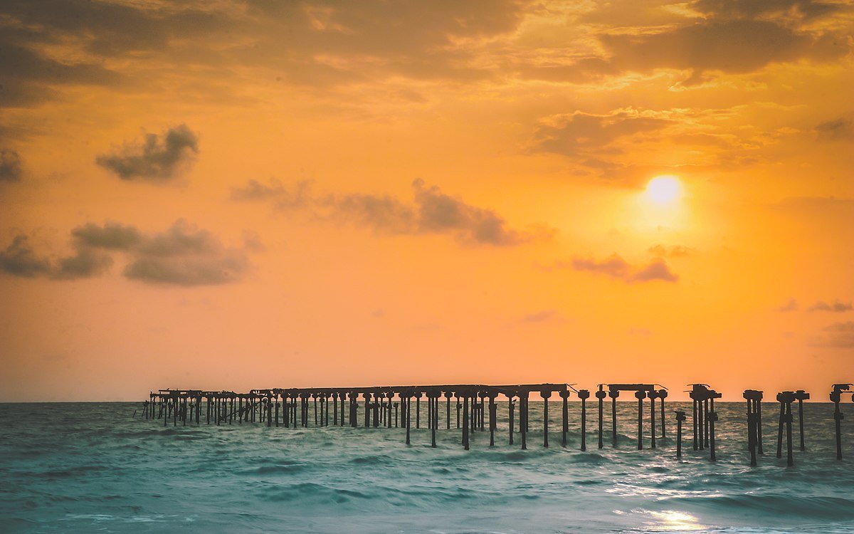 Alappuzha’s historic pier silhouetted at sunset