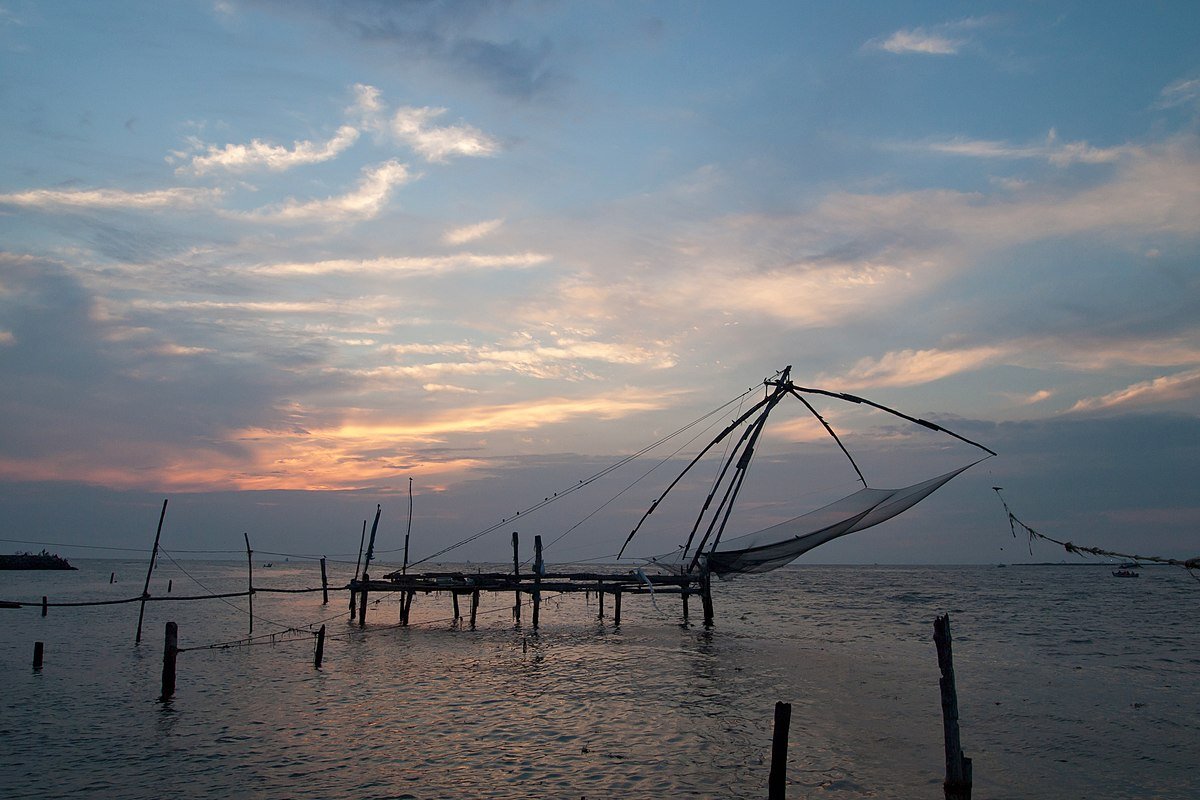 Fishing nets and the waterfront beneath a changing sky