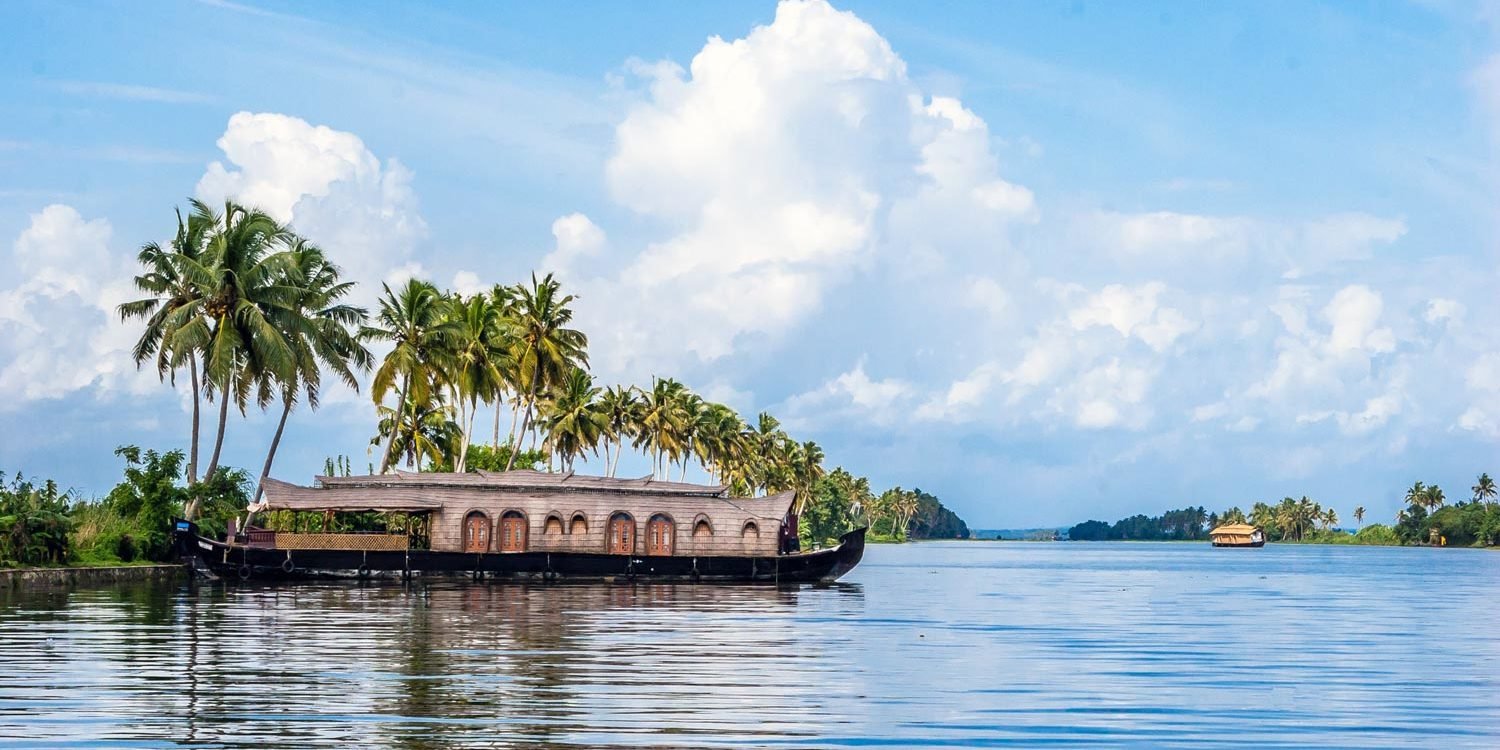 Houseboat and coconut palms along the Kumarakom backwaters