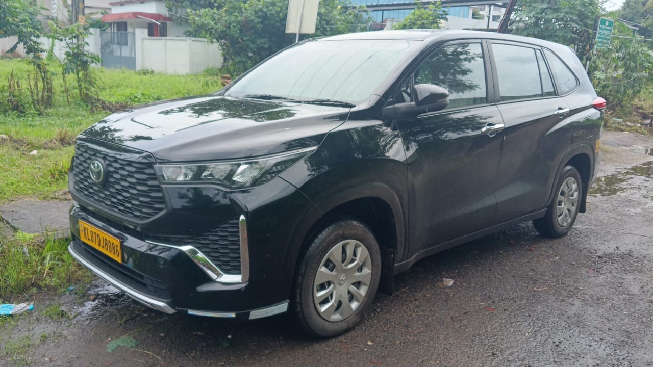 Toyota MPV photographed beside a green roadside